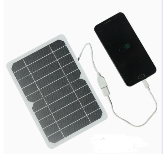 Portable 2W polycrystalline solar panel charger connected via USB to a smartphone on a white background